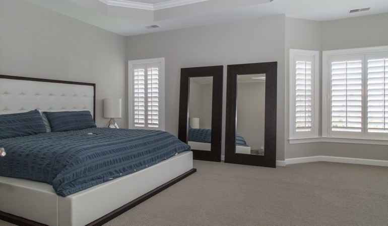 White shutters in a minimalist bedroom in Philadelphia.